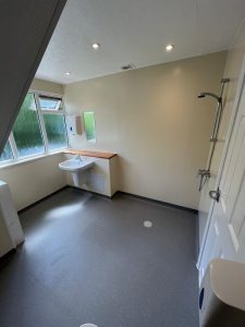 A wetroom with a sink and shower