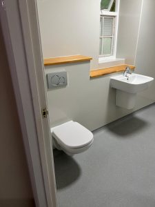A bathroom with a toilet and sink