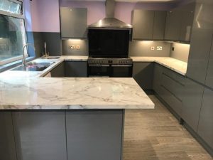 A kitchen with a marble counter top