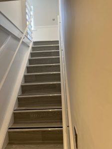 A staircase with a light in the background