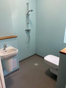 A bathroom with a sink, toilet and shower